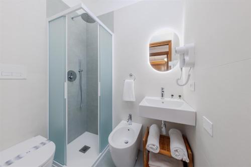 a white bathroom with a sink and a shower at Hotel Palladio in Malcontenta