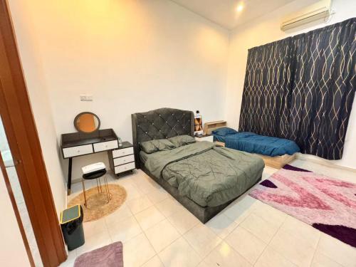 a bedroom with a bed and a desk in it at H&home in Kluang
