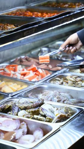 a display case with many different types of food at Zetter Suites @ Cameron in Cameron Highlands