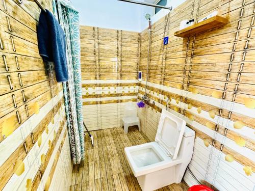 a bathroom with a toilet and a sink at Paradise Inn by HBR in Dharmsala