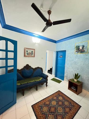 a living room with a couch and a ceiling fan at Dom Pedros Haven Resort - Tranquil Retreat by the Sea in Utorda