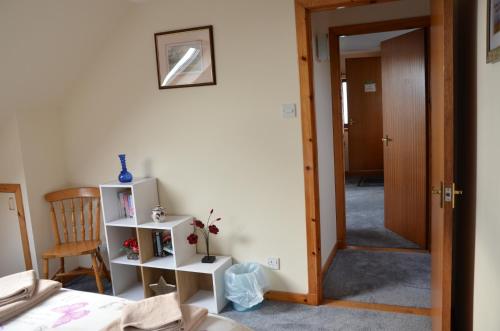 a bedroom with a door open to a room at Cozy Aultbea Apartment with Sea View in Aultbea