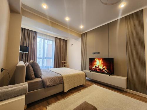 een slaapkamer met een bed en een open haard bij Residence Apartment Osh Шикарные апартаменты в самом Элитном районе города Ош in Osh