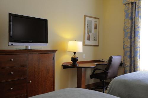 a bedroom with a television and a bed at Country Inn & Suites by Radisson, Orangeburg, SC in Orangeburg