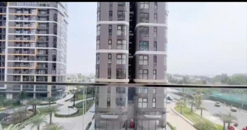 a view of a city with tall buildings from a window at Tommy Land in Gò Công