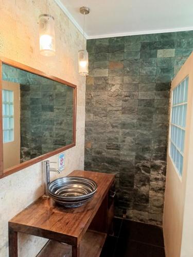 a bathroom with a sink and a mirror at La Luna Beach Resort in Guiuan