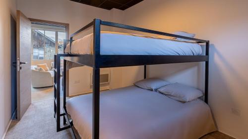 a bedroom with two bunk beds in a room at Le Dauphiné 2 - Allevard in Allevard
