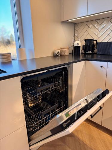 an oven with its door open in a kitchen at Ipu Puhkemaja - Riverside Holiday Home in Nasva