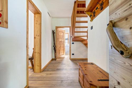 a tiny house with a staircase and a wooden floor at Baita Cisina in Stavel