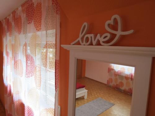 a room with a love sign on the wall at Ferienwohnung am Gässle in Ettenheim