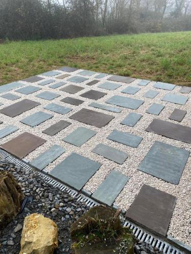 a stone walkway with a field in the background at Studio Apartment in Brigueuil-le-Chantre