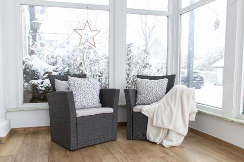 a living room with two chairs and a christmas tree at Hof Timmermann - Landhaus, unten in Ottenstein