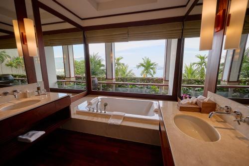 a bathroom with two sinks and a large window at Villa 29 Montebello Andara Resort Villas in Kamala Beach