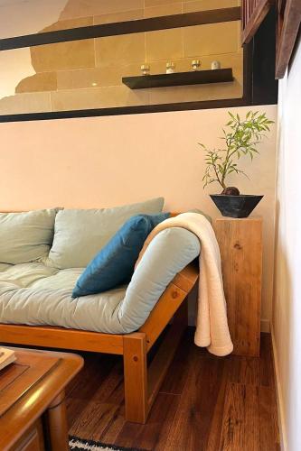 a couch with pillows on it in a room at Appartement, Nature, Relaxation et Demi-Pension Possible in Crévic