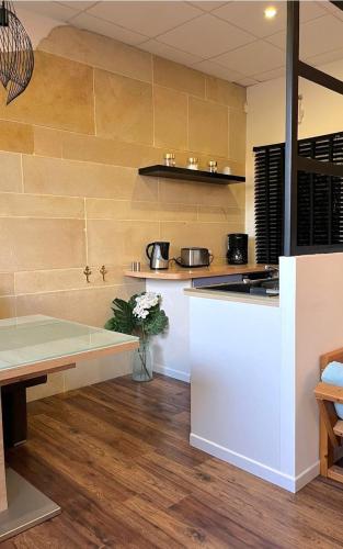 a kitchen with a table and a counter top at Appartement, Nature, Relaxation et Demi-Pension Possible in Crévic