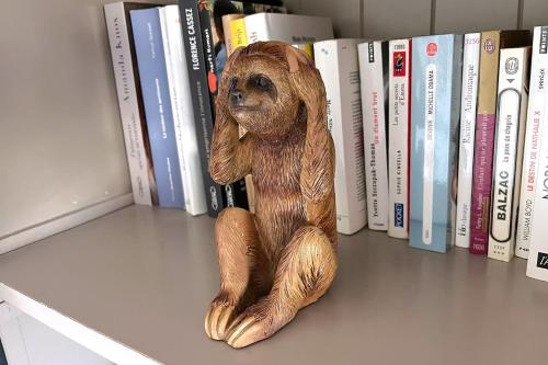 a statue of a stuffed bear sitting on a book shelf at Appartement, Nature, Relaxation et Demi-Pension Possible in Crévic