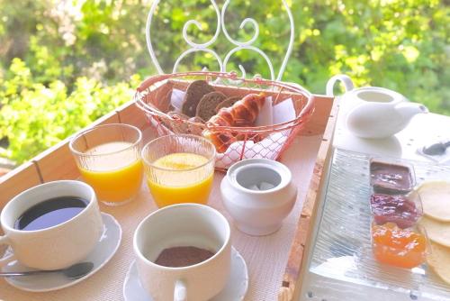 a tray of breakfast foods and drinks on a table at Appartement, Nature, Relaxation et Demi-Pension Possible in Crévic