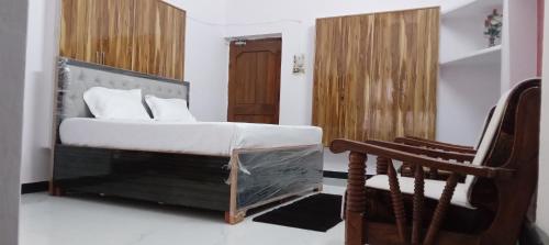 a bedroom with a bed and a chair at Shiv Ram home stay in Varanasi