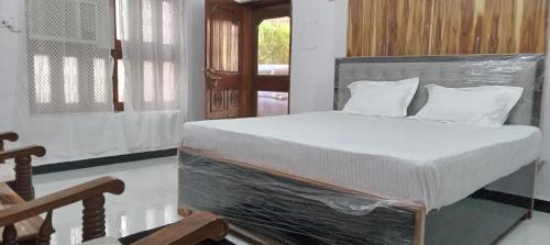 a bed with a plastic frame in a room at Shiv Ram home stay in Varanasi