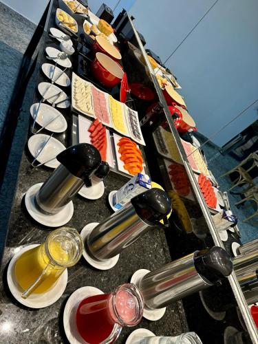 a row of wine bottles and glasses on a table at Hotel Premier in Belo Horizonte