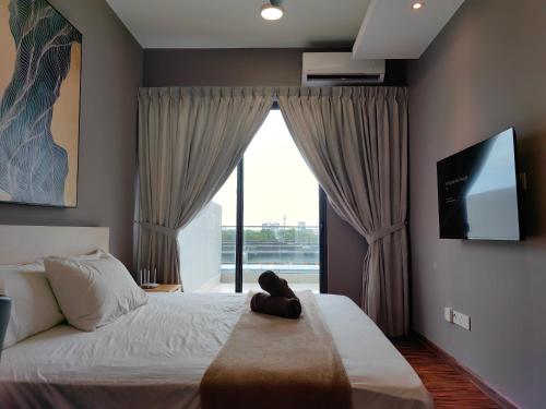 a bedroom with a bed and a large window at Near Airport K Avenue Family Room in Donggongon