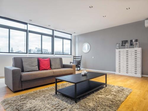a living room with a couch and a table at Rent Top Apartments Rambla Catalunya in Barcelona