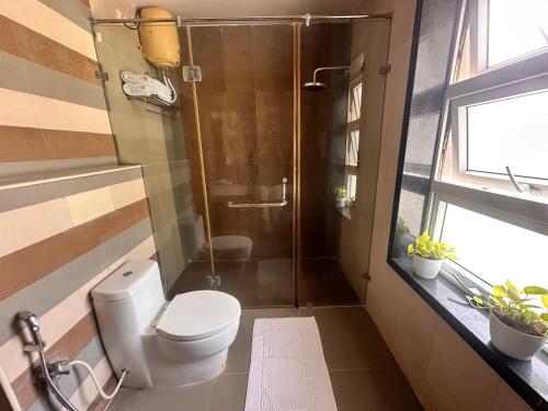 a bathroom with a toilet and a shower at Villa Bay by Youkoso in Chennai
