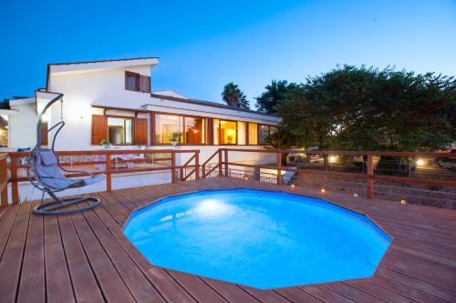 a swimming pool on a deck with a house at Appartamento in Villa con Terrazzo e Vista Golfo in Massa Lubrense