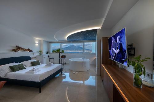 a bedroom with a bed and a bathroom with a tub at Relais Manfredi in Castellammare di Stabia