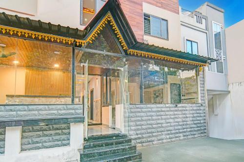 a house with a glass facade and stairs at Super Collection O Mahakal Formerly Maharana Pratap in Ujjain