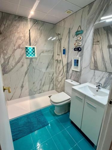 a bathroom with a toilet and a sink and a shower at Casa L’Augusta in Altafulla