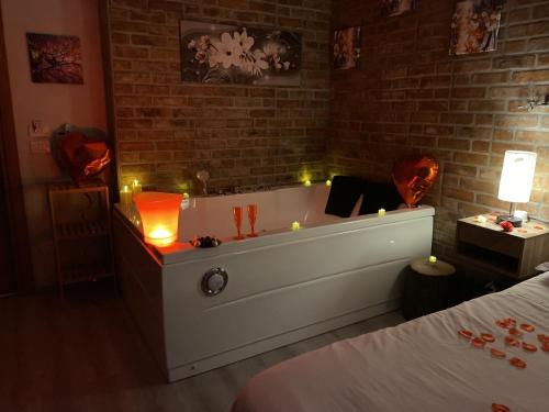 a room with a bath tub with candles in it at Perugia Suite in Perugia