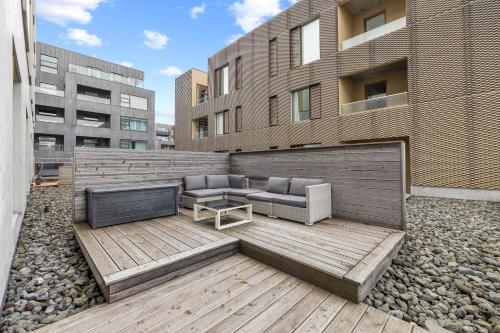 a patio with a couch and a table and a building at Unbeatable Central Location - Reykjavíks Most Exclusive Luxury Apartments in Reykjavík