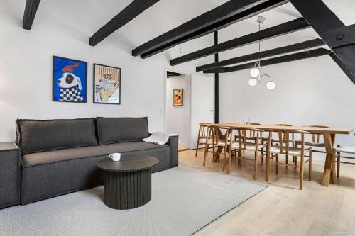 a living room with a couch and a table at City-Center Penthouse w Private Balcony in Aarhus