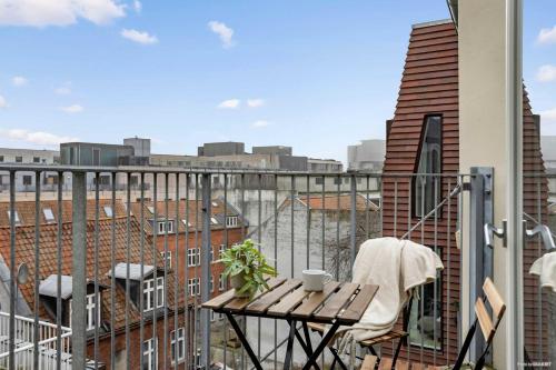 a balcony with a table and a view of a city at City-Center Penthouse w Private Balcony in Aarhus