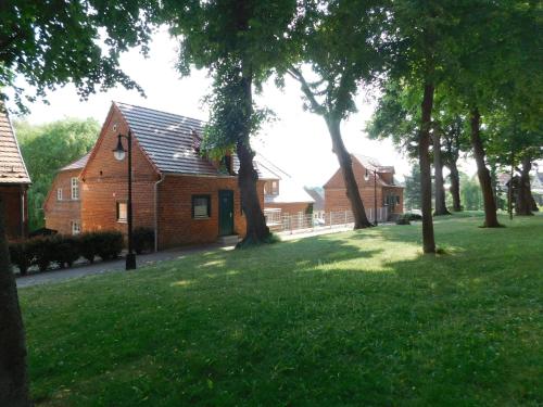 a house with a yard with trees in front of it at Pfarrscheune in Bad Sülze