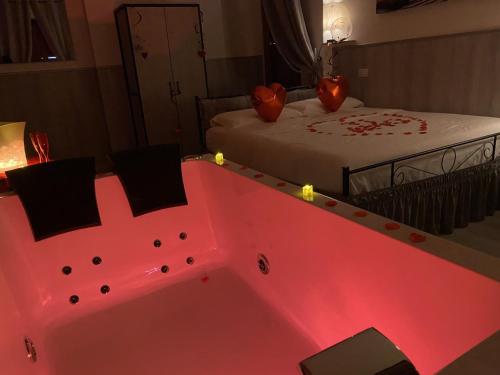 a pink bathtub in a room with a bed at Perugia Suite in Perugia