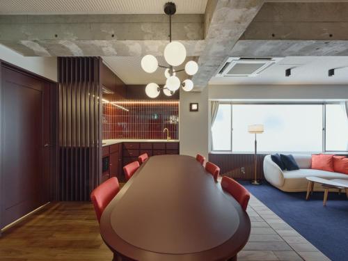 a conference room with a table and a couch at illi Tex Aoyama in Tokyo