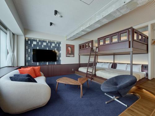 a bedroom with two bunk beds and a couch at illi Tex Aoyama in Tokyo