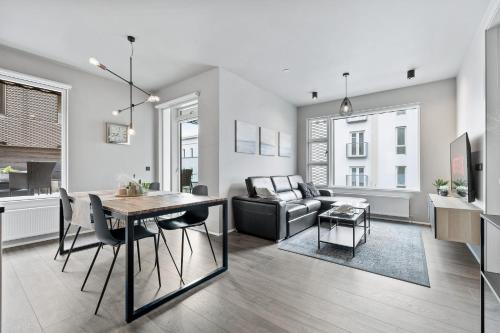 a living room with a table and a couch at Unbeatable Central Location - Reykjavíks Most Exclusive Luxury Apartments in Reykjavík