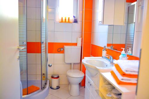 a bathroom with a toilet and a sink and a shower at Apartment Mirela in Sarajevo