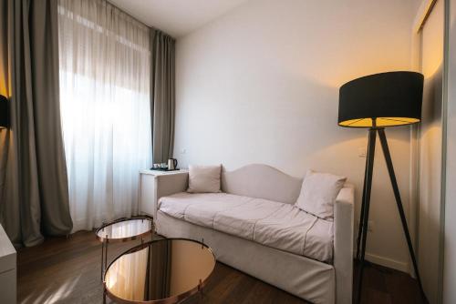 a living room with a couch and a table at Hotel De La Ville in Riccione