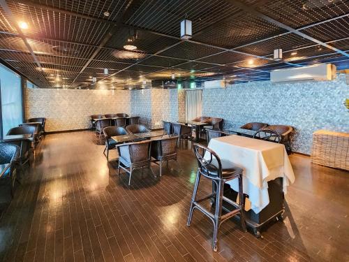 a dining room with tables and chairs in a room at Hotel Cetus Royal in Higashiizu