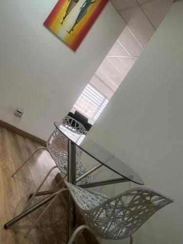 a glass table and a chair in a room at Colossume in Johannesburg