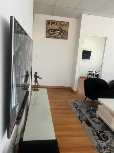 a living room with a flat screen tv on a wall at Colossume in Johannesburg