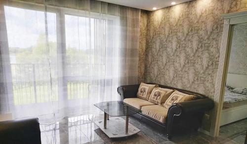 a living room with a couch and a glass table at Gilužio Apartments in Vilnius