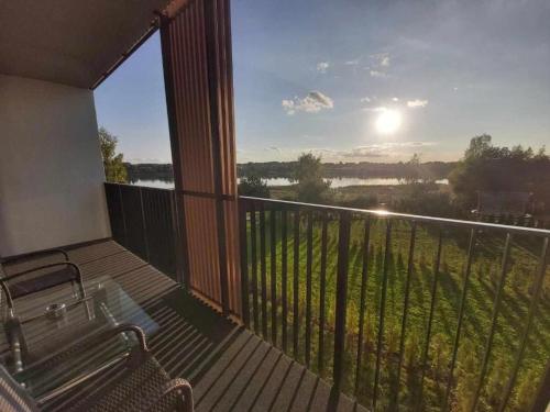 a balcony with a bench and a view of a river at Gilužio Apartments in Vilnius
