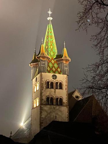 a tower with a cross on top of a building at Auberge Le Meisenberg in Châtenois