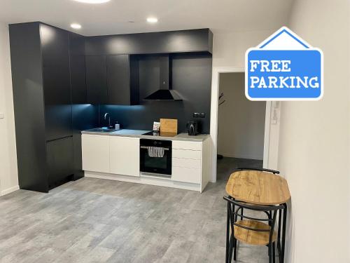 a kitchen with a free parking sign on the wall at Central Apartments Opava in Opava