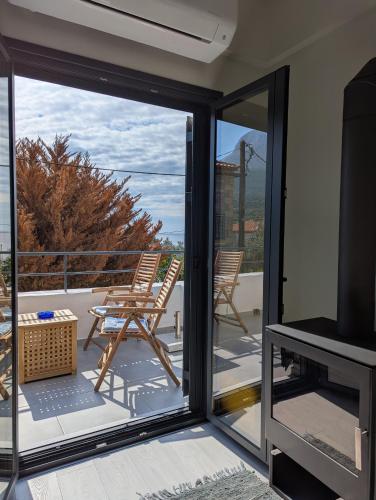a sliding glass door with a view of a patio at kipaki-trachila Mani in Trakhíla